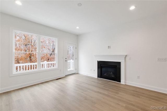 unfurnished living room featuring light wood-type flooring