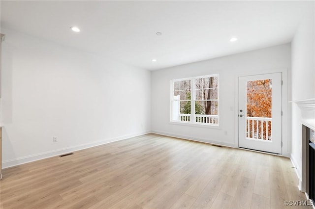 unfurnished living room featuring light hardwood / wood-style floors