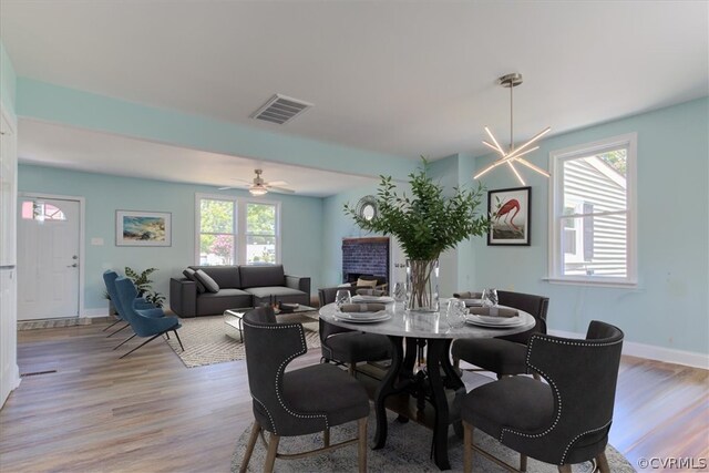 dining room with light hardwood / wood-style flooring and ceiling fan