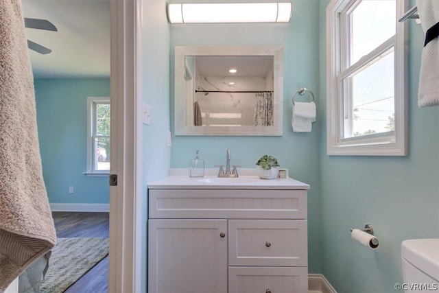 bathroom featuring an AC wall unit, wood-type flooring, vanity, toilet, and a shower with shower curtain