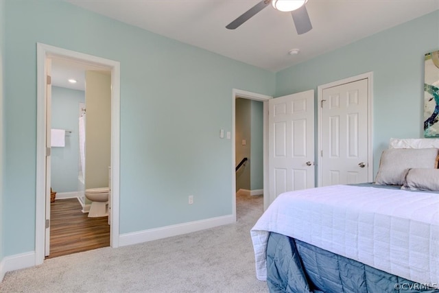 bedroom with light carpet, ceiling fan, and ensuite bathroom