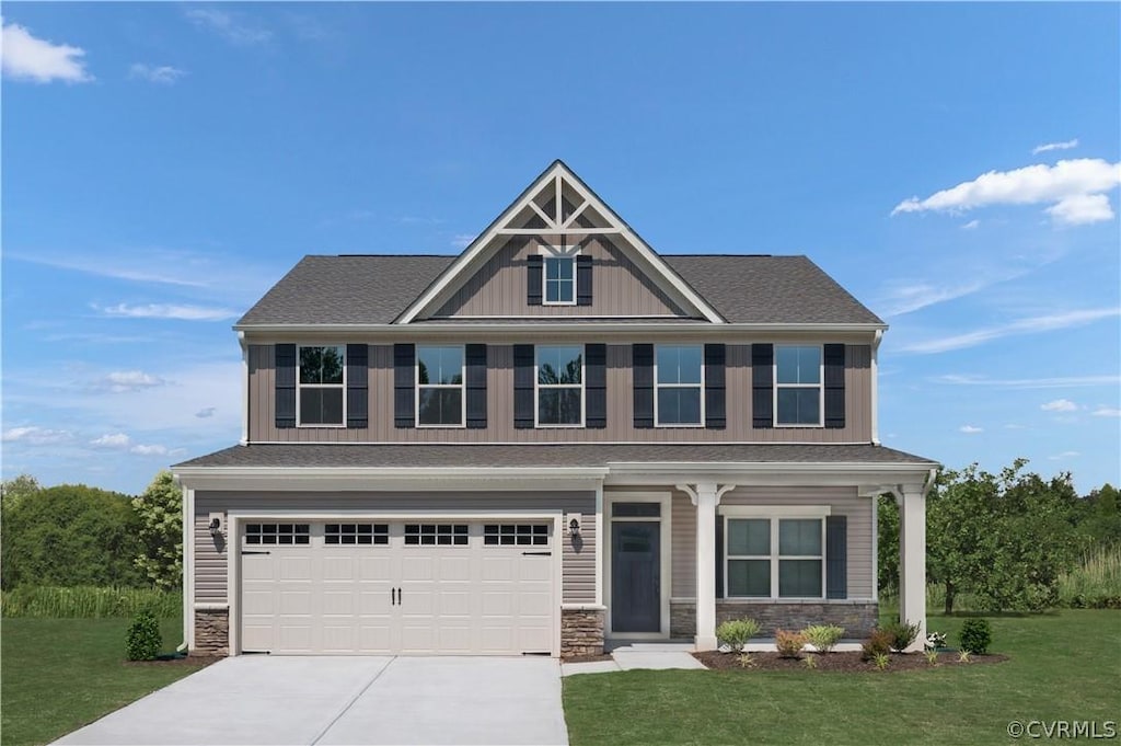 craftsman house featuring a garage and a front lawn