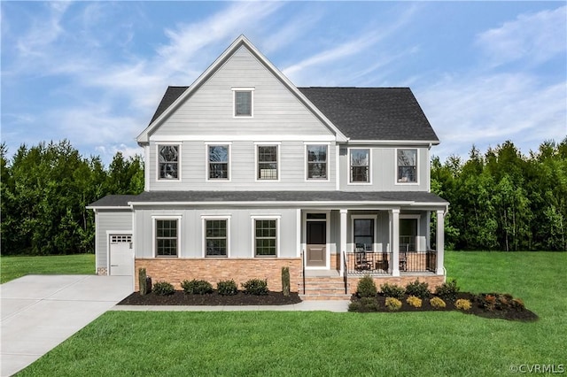 view of front facade with a front yard, a porch, and a garage