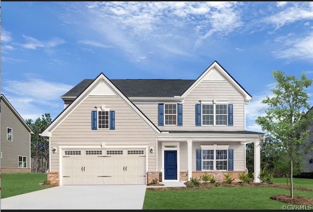 view of front of property with a front yard and a garage