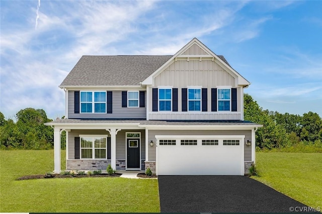 craftsman house with a front yard and a garage