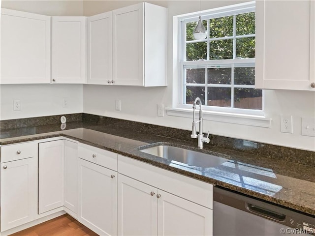 1608 Mechanicsville Tpke, Richmond, VA 23223 - kitchen featuring pendant lighting, dark stone counters, sink, stainless steel dishwasher, and white cabinetry