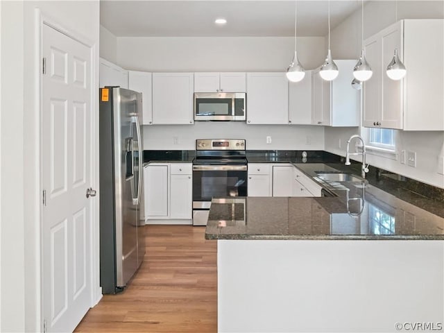 1608 Mechanicsville Tpke, Richmond, VA 23223 - kitchen featuring kitchen peninsula, decorative light fixtures, stainless steel appliances, and sink