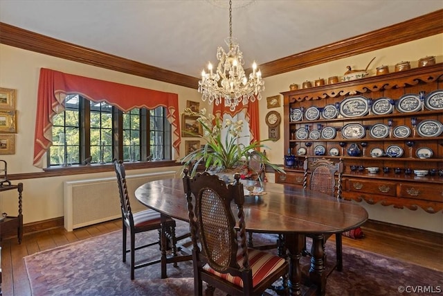 dining room featuring radiator, an inviting chandelier, ornamental molding, and wood-type flooring