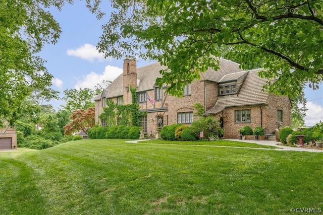 tudor home with a front lawn