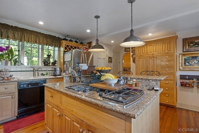 kitchen featuring light stone countertops, dishwasher, a center island, stainless steel gas stovetop, and dark hardwood / wood-style flooring