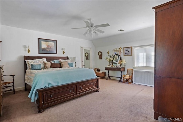 bedroom featuring lofted ceiling, light carpet, radiator heating unit, and ceiling fan