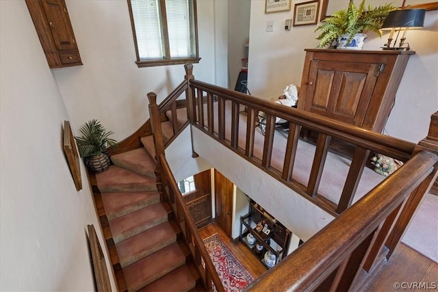 stairway with hardwood / wood-style flooring