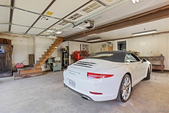 garage with a garage door opener and water heater