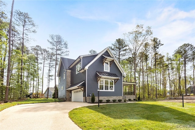 view of front of home with a garage and a front lawn