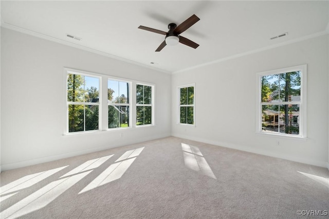 empty room with light colored carpet, ornamental molding, and ceiling fan