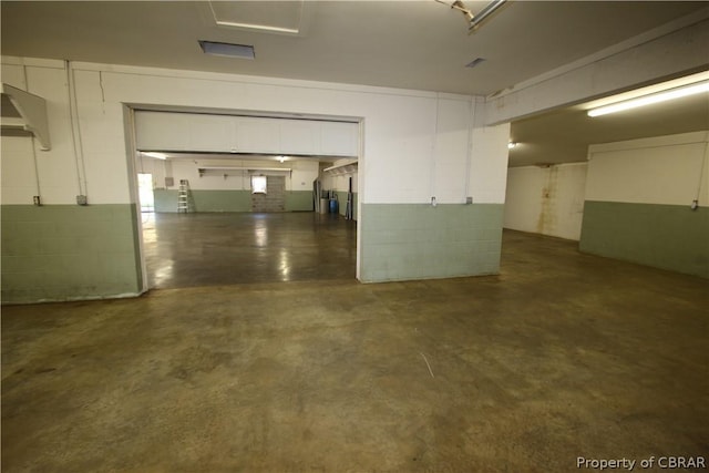 garage with concrete block wall