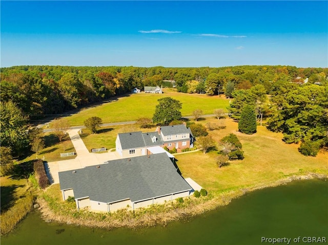 birds eye view of property featuring a view of trees