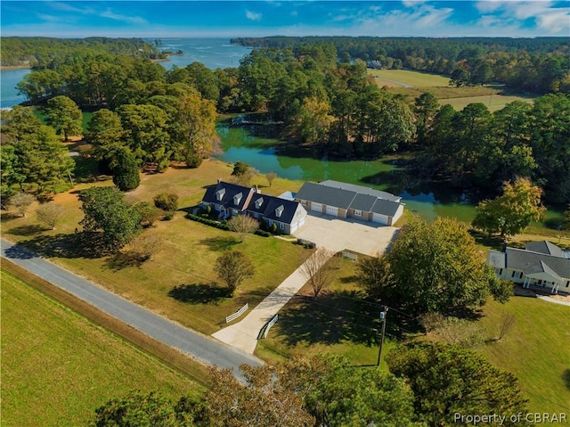 drone / aerial view featuring a water view and a view of trees