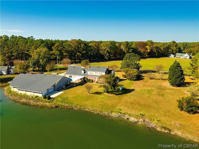 drone / aerial view featuring a water view and a wooded view