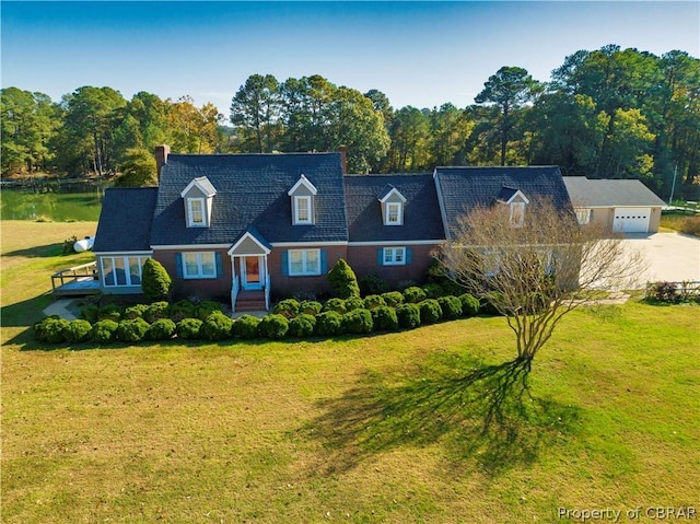 cape cod-style house with driveway, brick siding, an attached garage, and a front yard