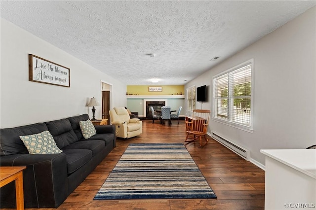 living room with a baseboard radiator, a textured ceiling, and dark wood-type flooring