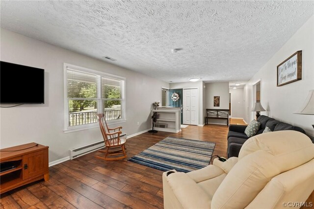 living room featuring a textured ceiling, a baseboard heating unit, and hardwood / wood-style floors