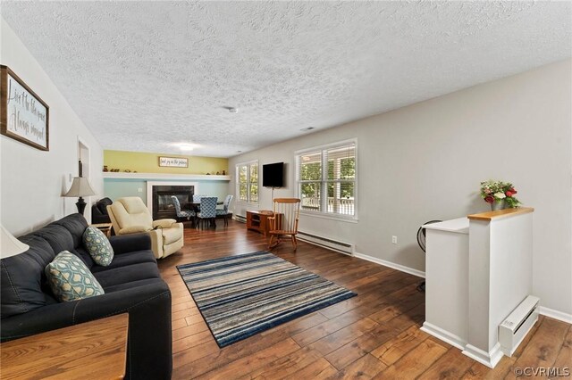 living room featuring a baseboard radiator, a textured ceiling, and hardwood / wood-style flooring