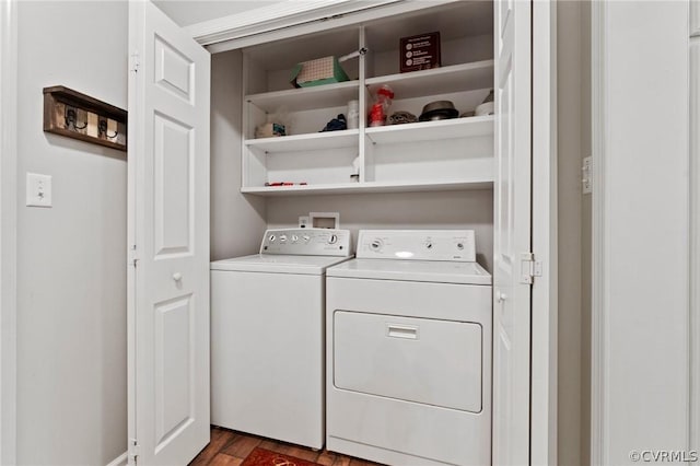 laundry area featuring washing machine and clothes dryer and dark hardwood / wood-style floors