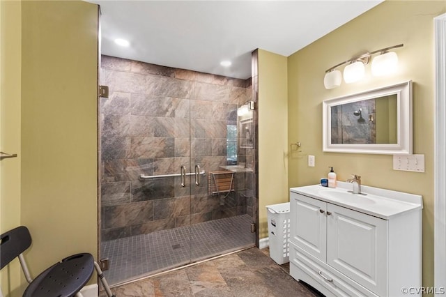 bathroom featuring tiled shower, tile patterned floors, and vanity