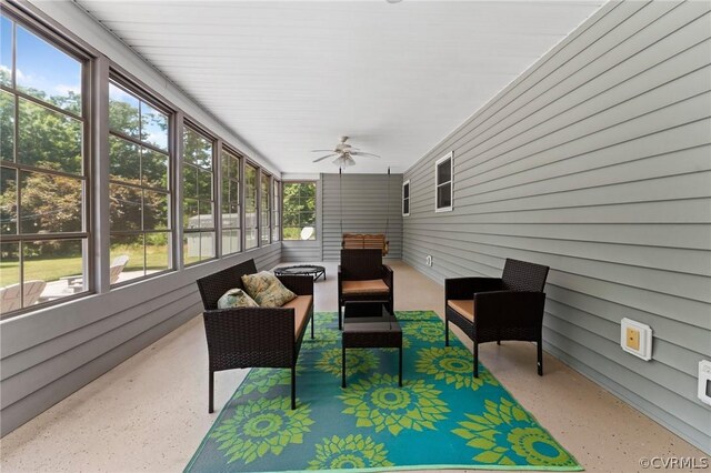 sunroom featuring ceiling fan