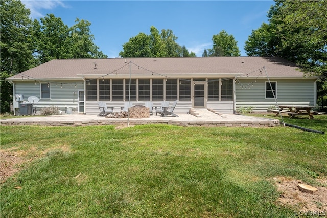 back of property with a patio and a yard