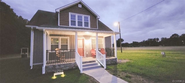 exterior space with a porch and a front yard