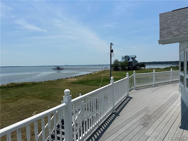 wooden deck with a yard and a water view