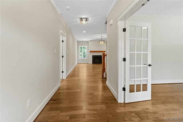 corridor with hardwood / wood-style floors