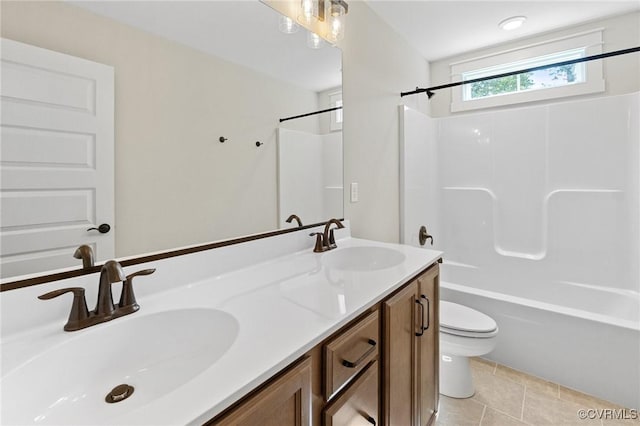 full bath with a sink, toilet, double vanity, and tile patterned floors