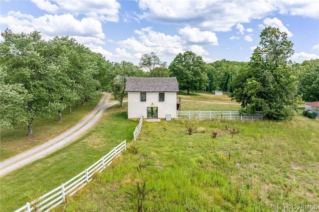 view of front facade featuring a front yard and a rural view