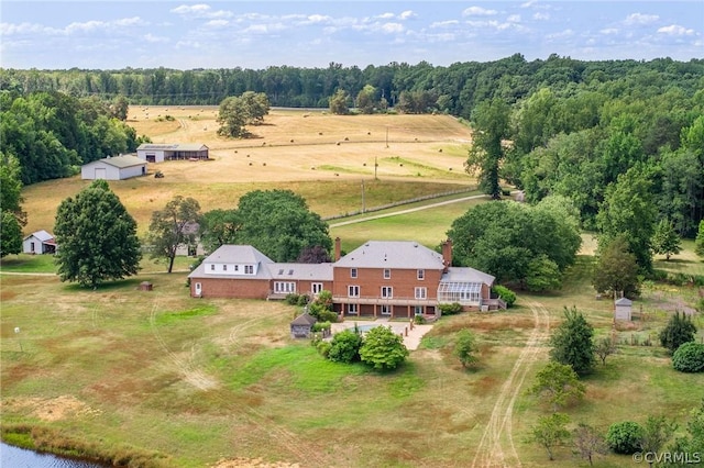 birds eye view of property with a rural view and a wooded view