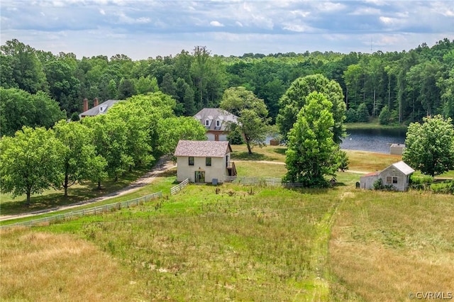 bird's eye view featuring a forest view and a water view