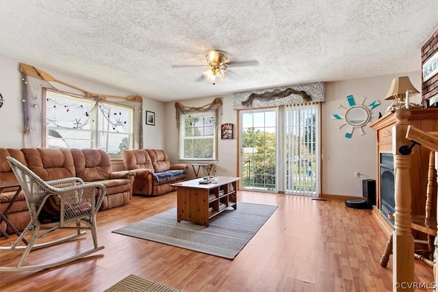 living room featuring ceiling fan and light hardwood / wood-style floors