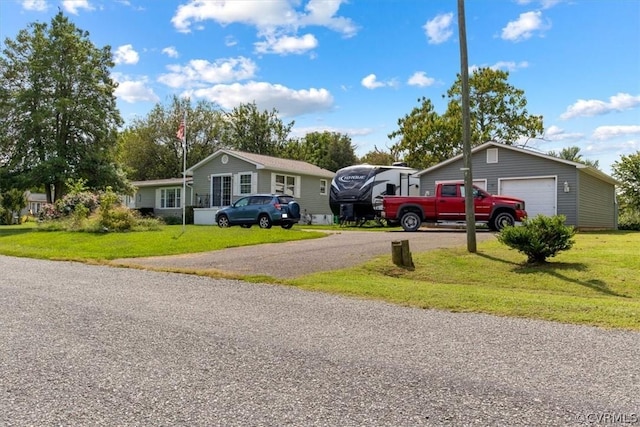 view of front facade featuring a garage, an outbuilding, and a front yard