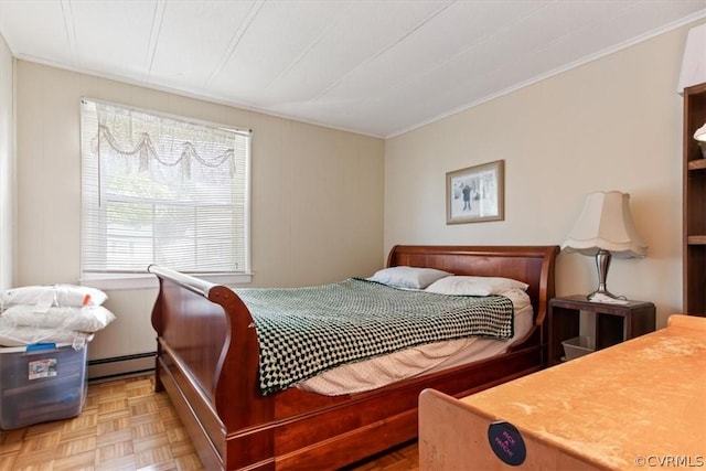 bedroom with light parquet flooring and a baseboard heating unit