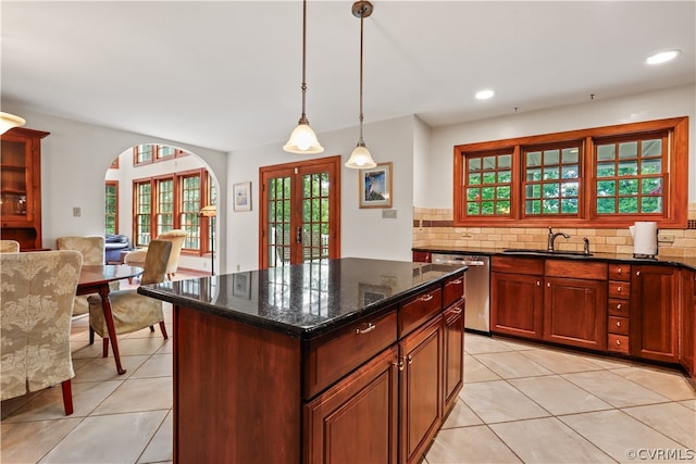 kitchen featuring light tile patterned floors, french doors, decorative backsplash, and dishwasher