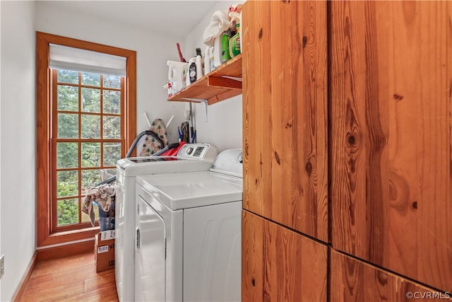 washroom with washer and dryer and light hardwood / wood-style floors