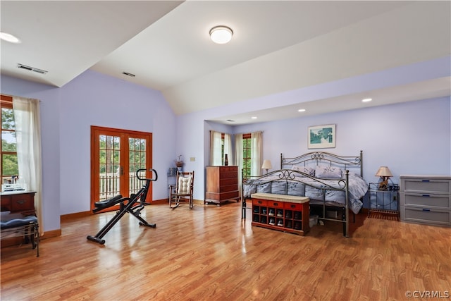 bedroom featuring vaulted ceiling, french doors, and light hardwood / wood-style floors