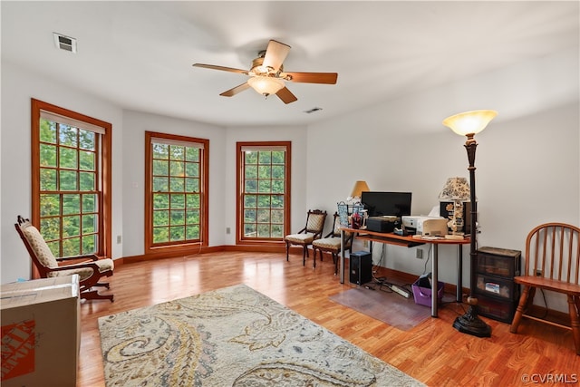 office area with light hardwood / wood-style flooring and ceiling fan