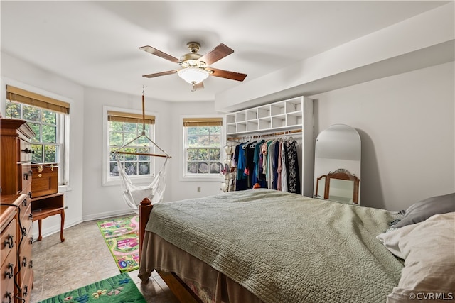 tiled bedroom with a closet and ceiling fan