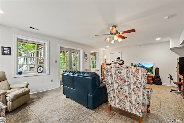 living room featuring ceiling fan, light tile patterned floors, and french doors