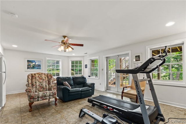 exercise area featuring light tile patterned floors and ceiling fan