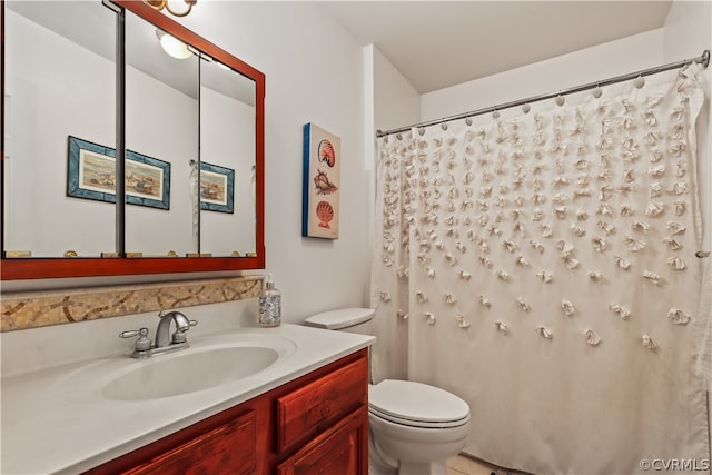 bathroom featuring toilet and vanity