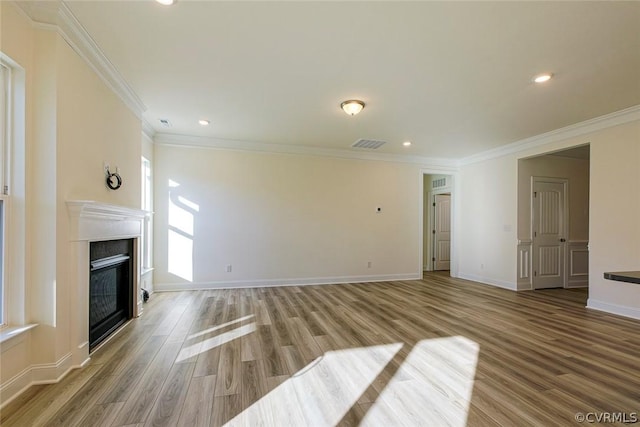 unfurnished living room featuring crown molding and light wood-type flooring